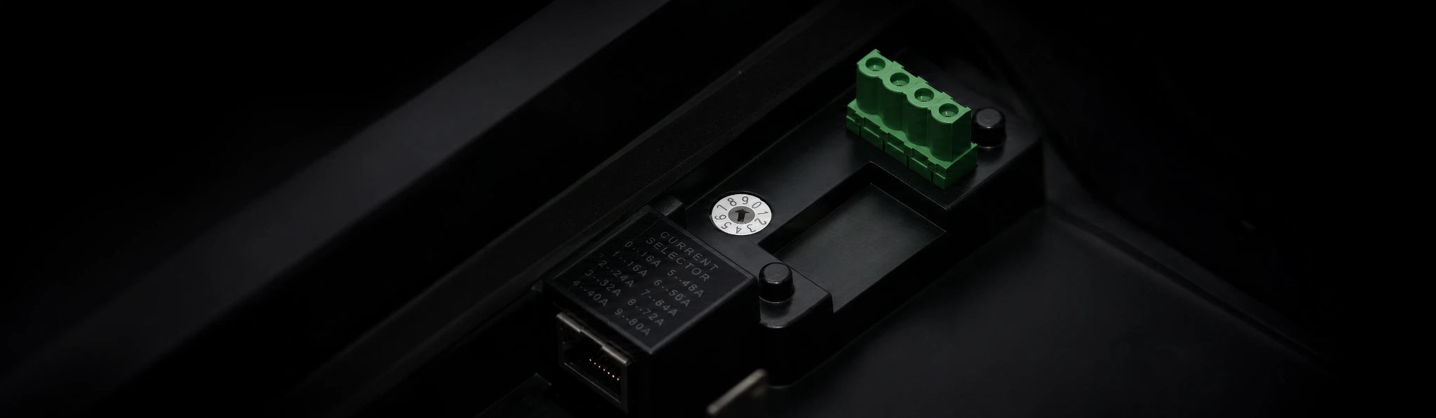 A close view of the charger's internal current selector and wiring terminals